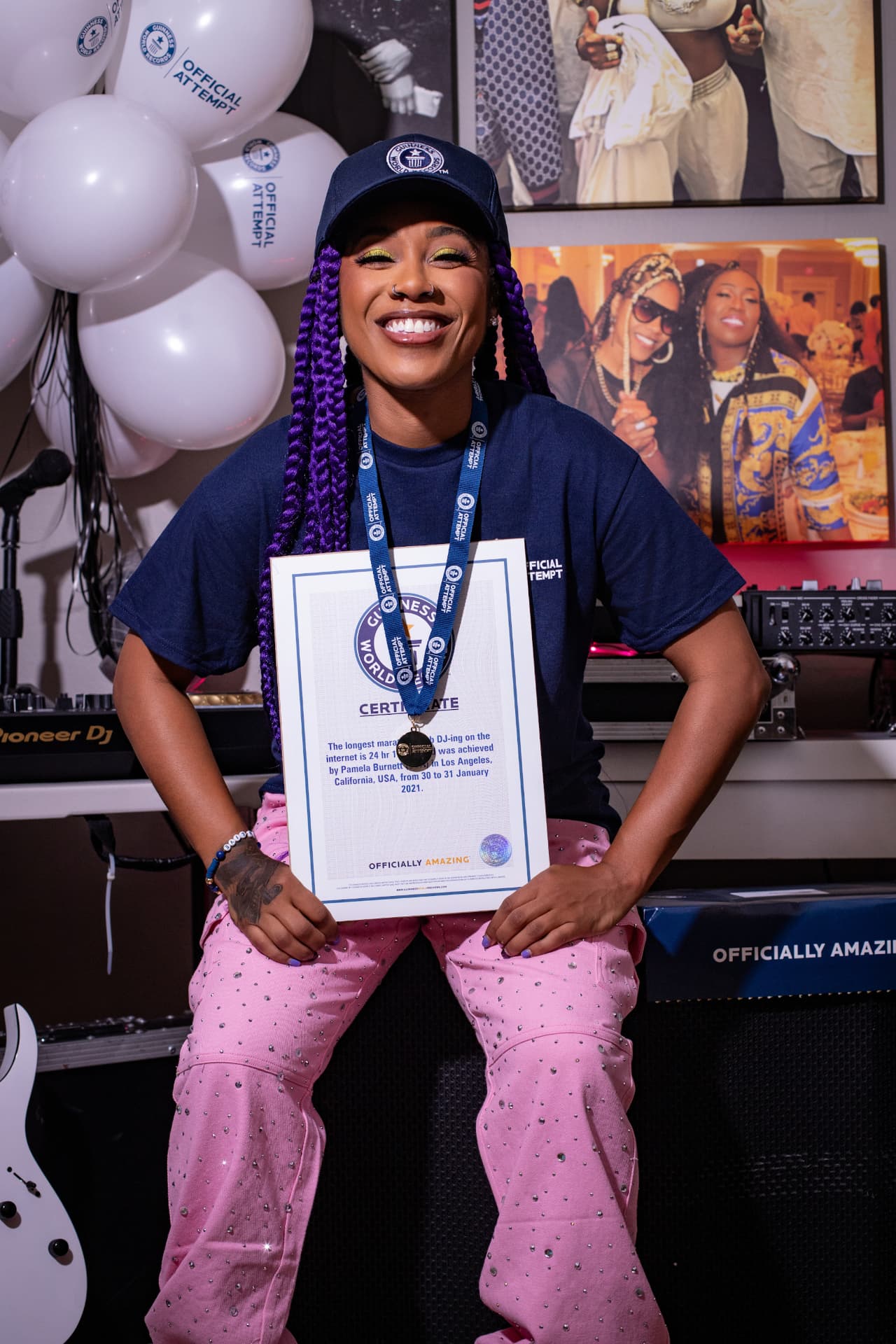 DJ PZB holding her Guinness World Records certificate in official gear