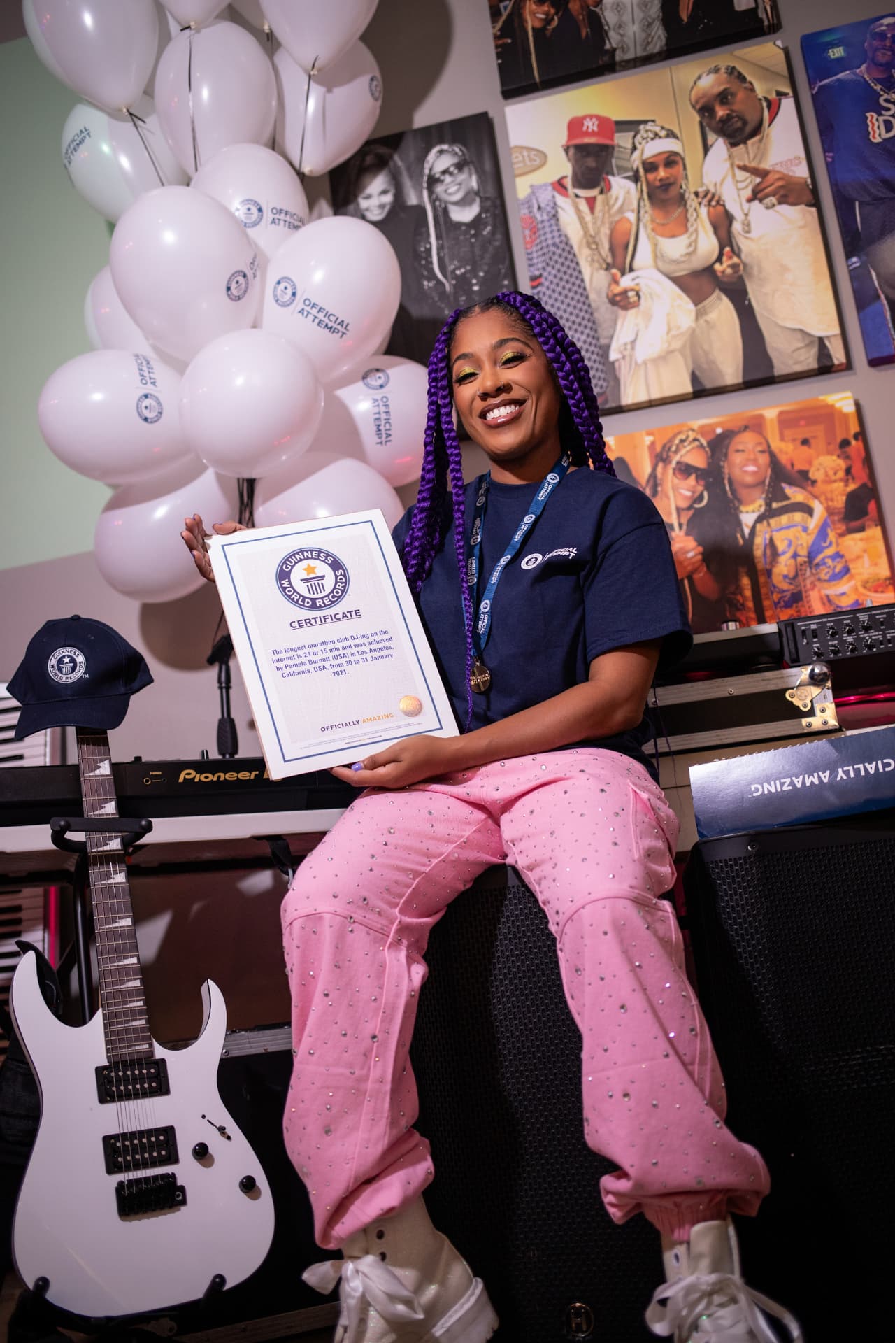 DJ PZB seated with her Guinness World Records certificate